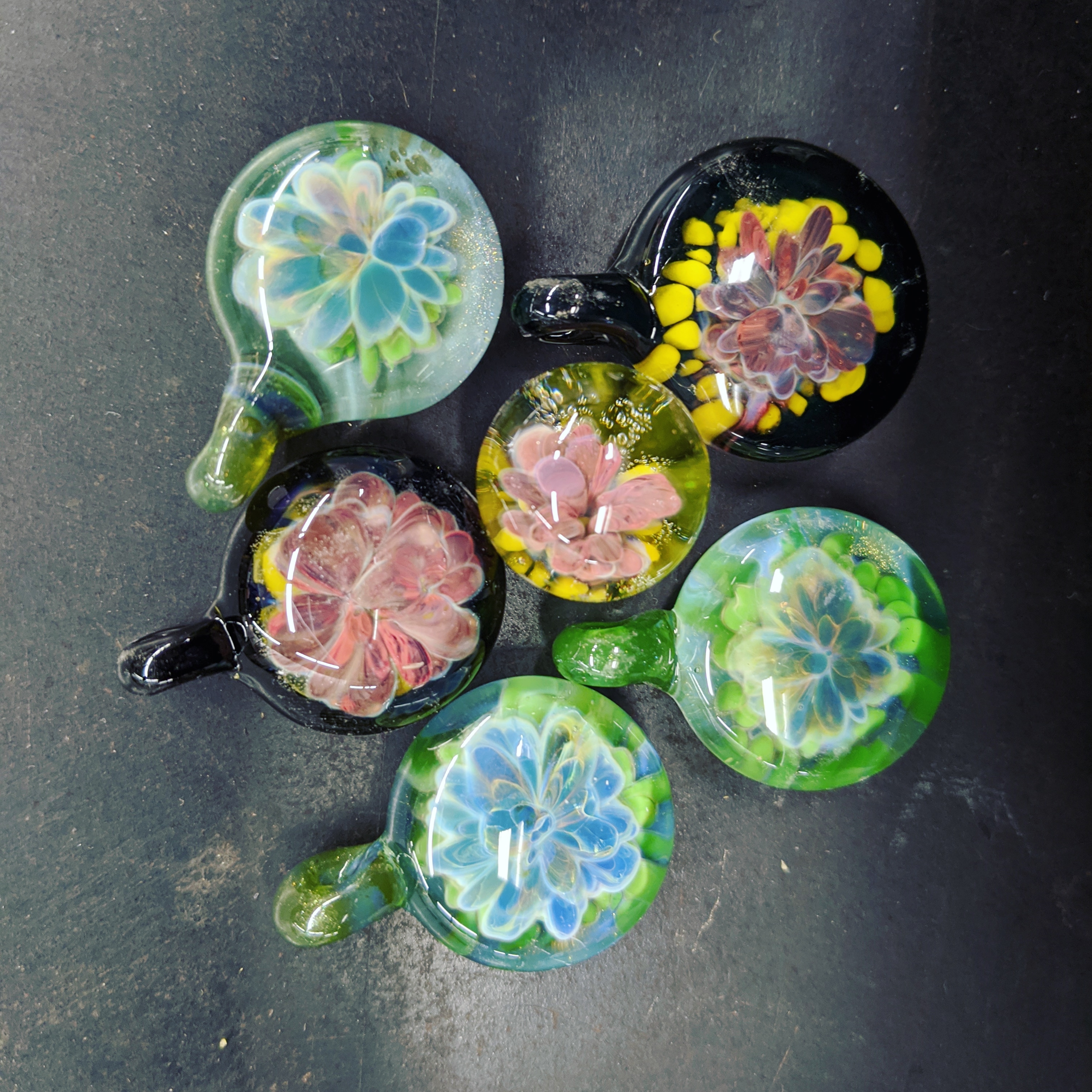 glass pendants with flower designs, waiting for me to make necklaces to display them