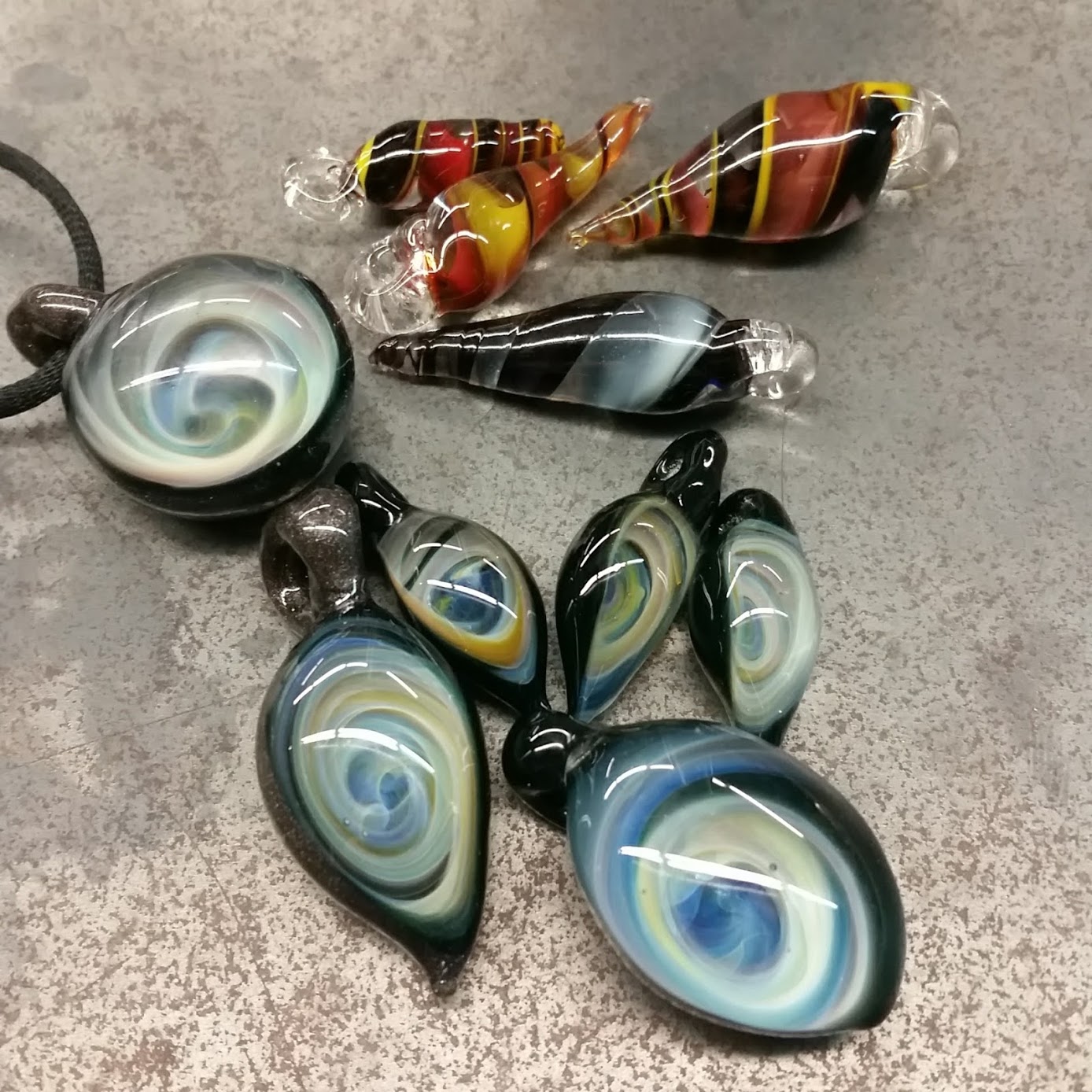 variety of glass pendants, including both vortex and spiral designs