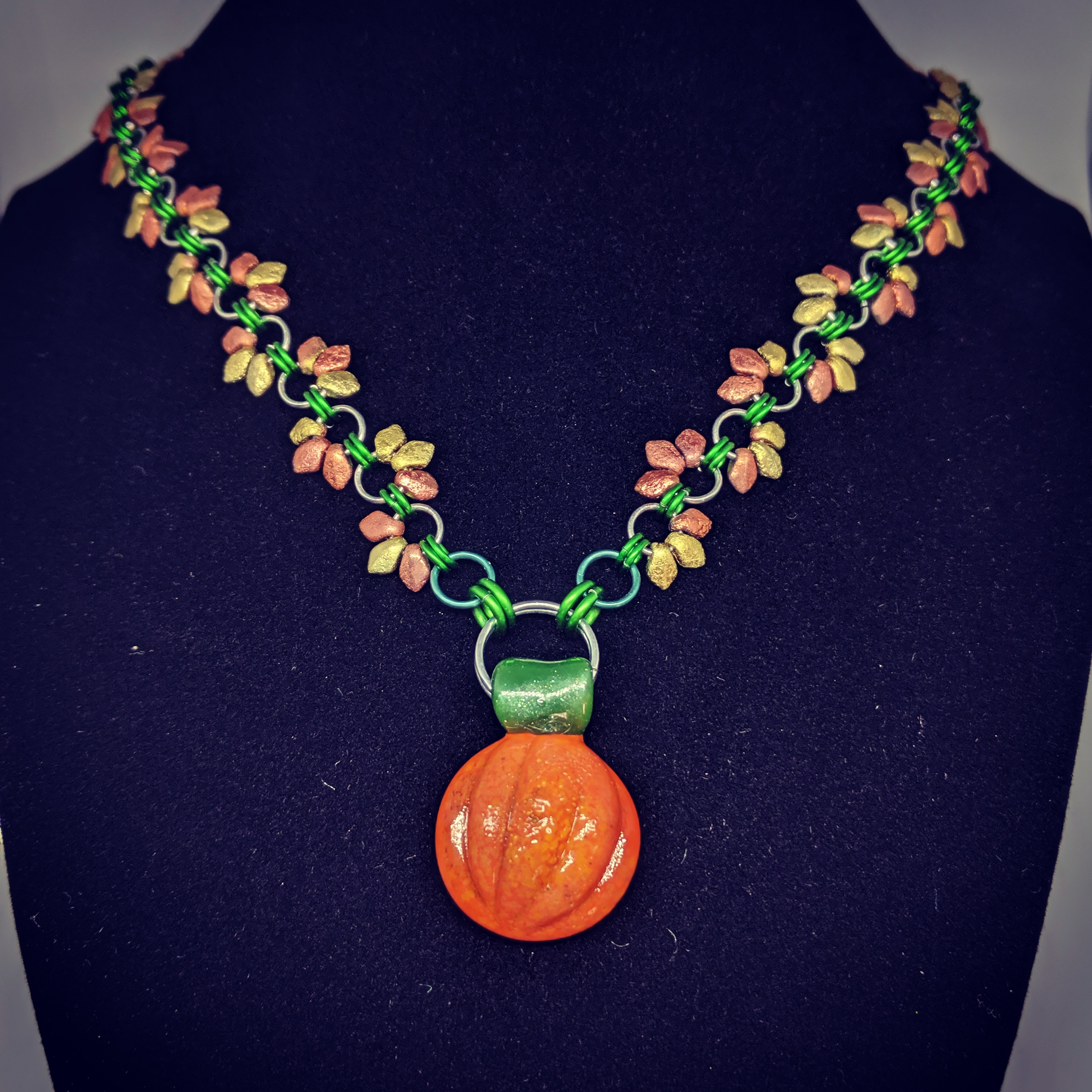pumpkin glass pendant on a chainmaille neckalce